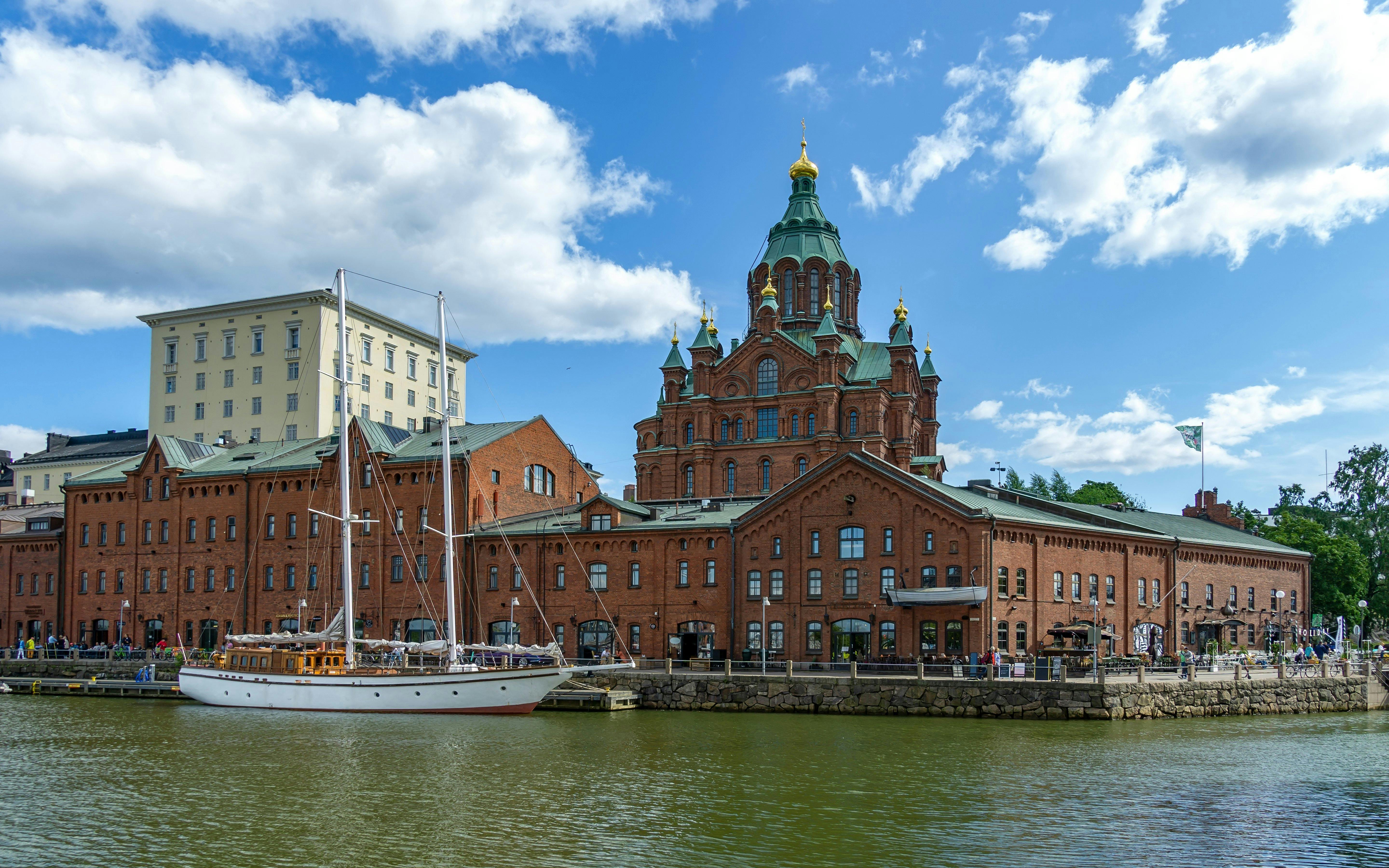 Helsinki harbor with Uspenski Cathedral and sailboat, Finland.
