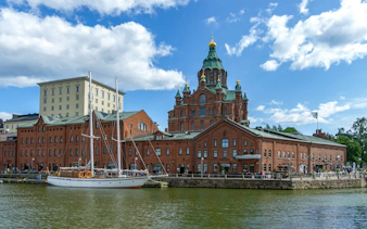 Helsinki harbor with Uspenski Cathedral and sailboat, Finland.