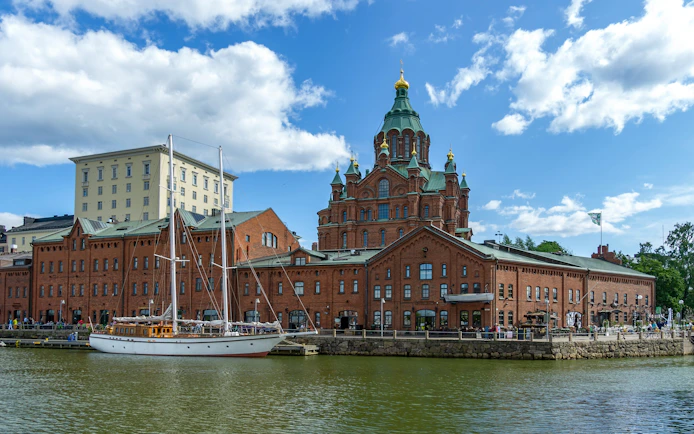 Helsinki harbor with Uspenski Cathedral and sailboat, Finland.