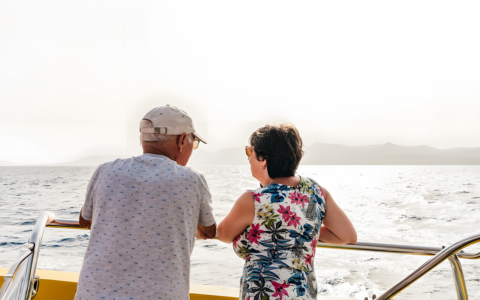Tourists enjoying sunset views on a speedboat during a dolphin cruise.