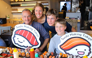 Family enjoying sushi making class in Asakusa, Tokyo with sushi platters.