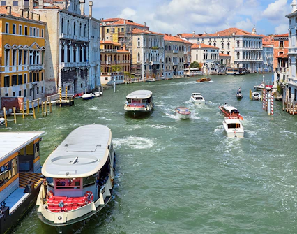 Vaporetto on Grand Canal, Venice, Italy with historic buildings in view.