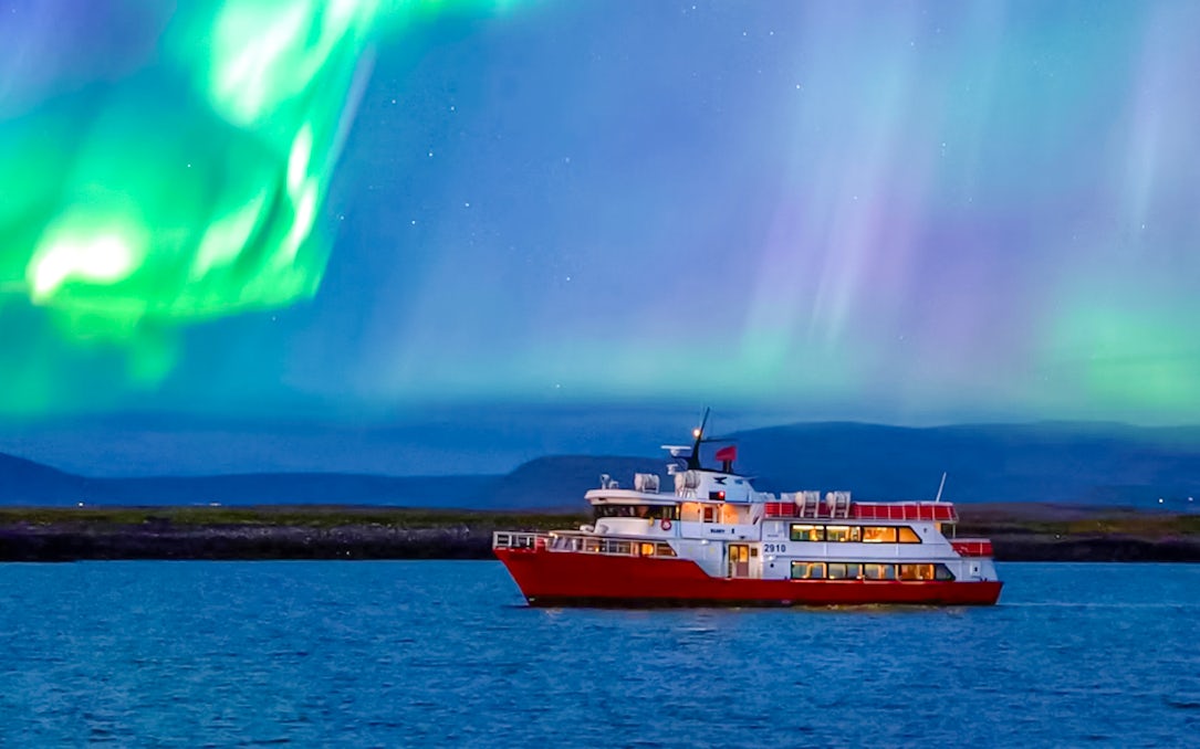 Cruise ship under northern lights in Iceland.