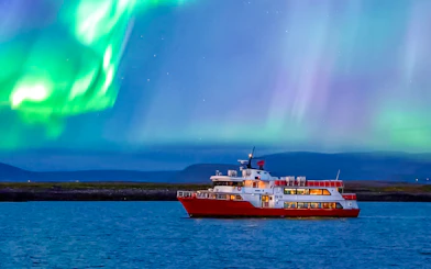 Cruise ship under northern lights in Iceland.