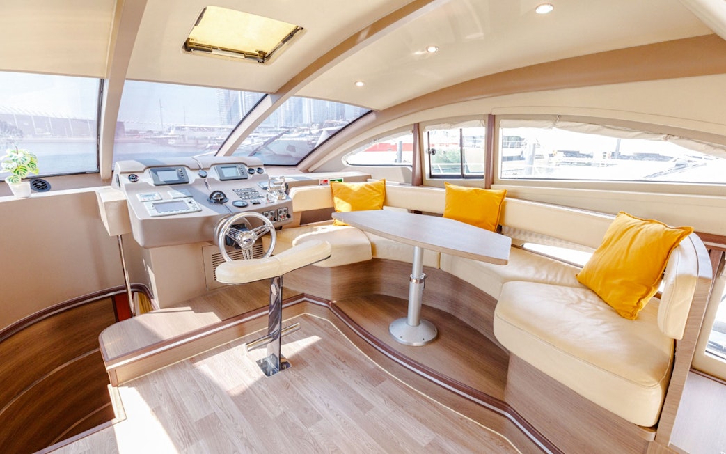 Interior of VERONIKA Private Luxury Yacht with helm, seating, and large windows.