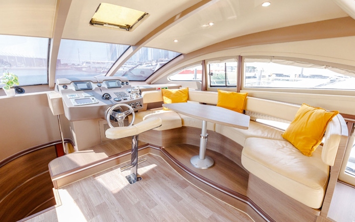 Interior of VERONIKA Private Luxury Yacht with helm, seating, and large windows.