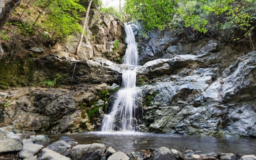 Waterfall cascading over rocks in Troodos Mountains, Cyprus forest.