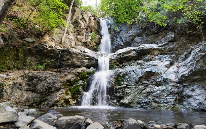 Waterfall cascading over rocks in Troodos Mountains, Cyprus forest.