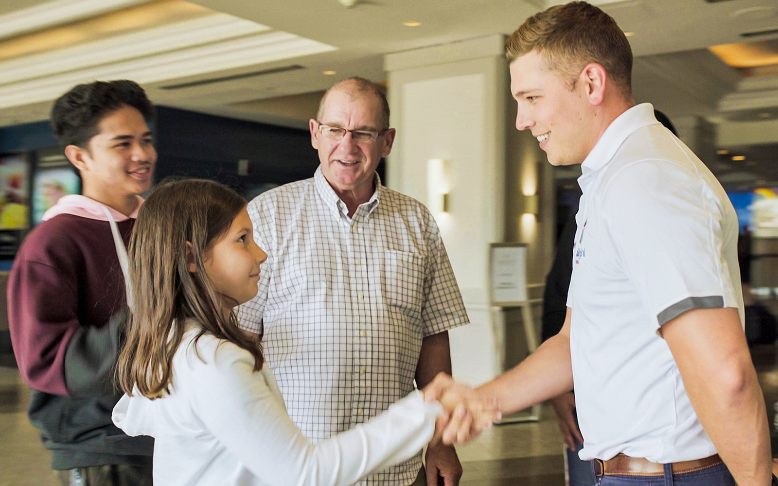 Local tour guide greeting guests in a hotel lobby.