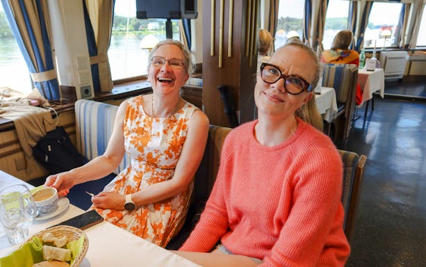 Guests enjoying brunch on a Danube River sightseeing cruise with live music.