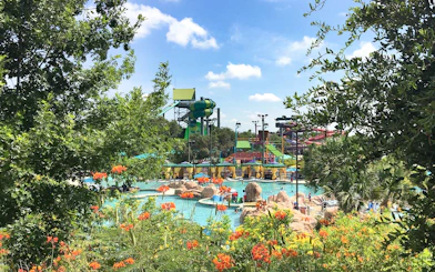 Water slides and pools at Aquatica San Antonio, Texas, surrounded by lush greenery.