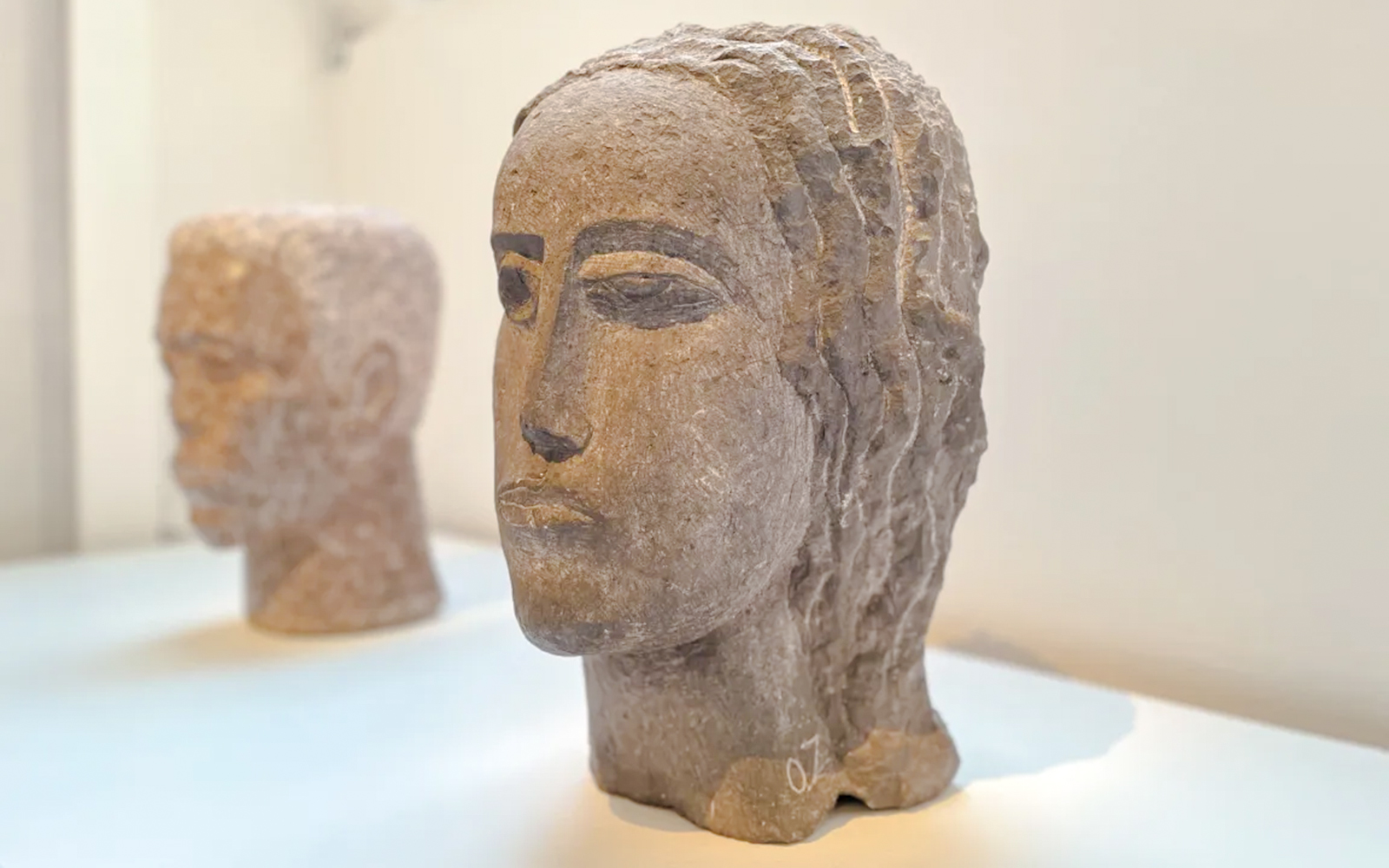 Sculpted stone heads on display at Zadkine Museum, Paris.