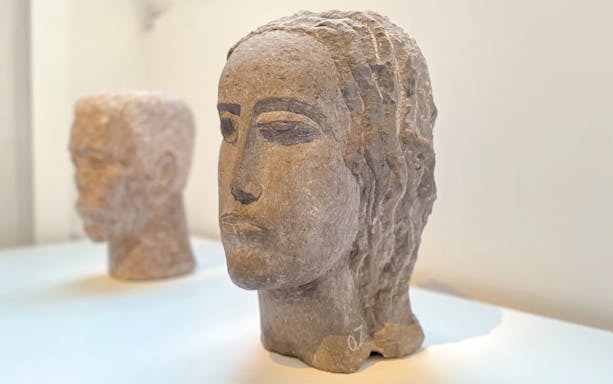 Sculpted stone heads on display at Zadkine Museum, Paris.