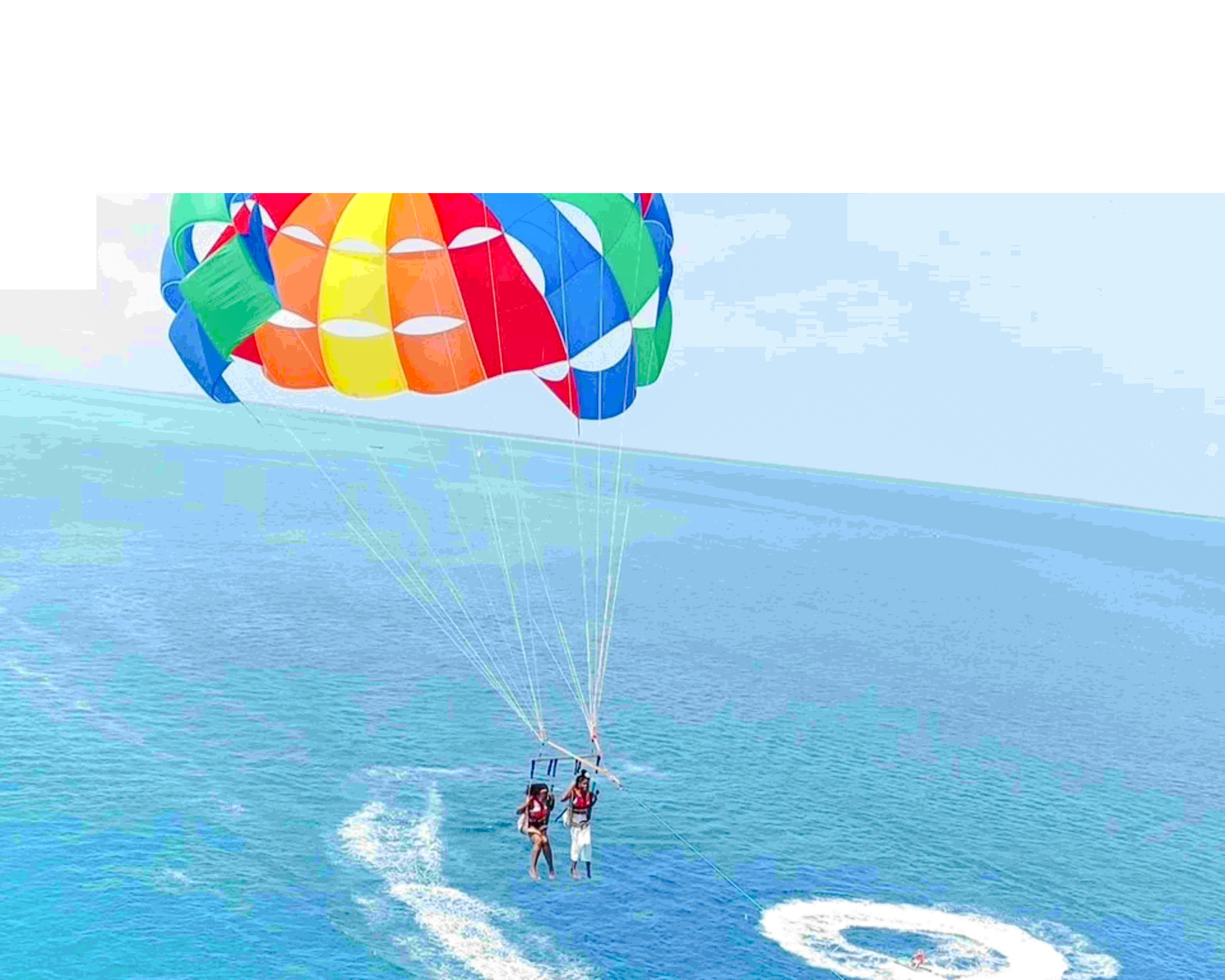 Parasailing over the Indian Ocean in Zanzibar with colorful parachute.
