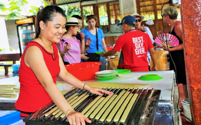 Woman demonstrating traditional candy making on Mekong Delta Full Day Tour.