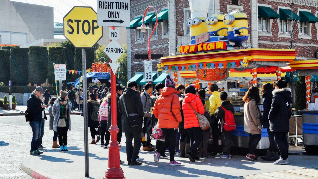 Visitors at Minion-themed food stand, Universal Studios Japan.
