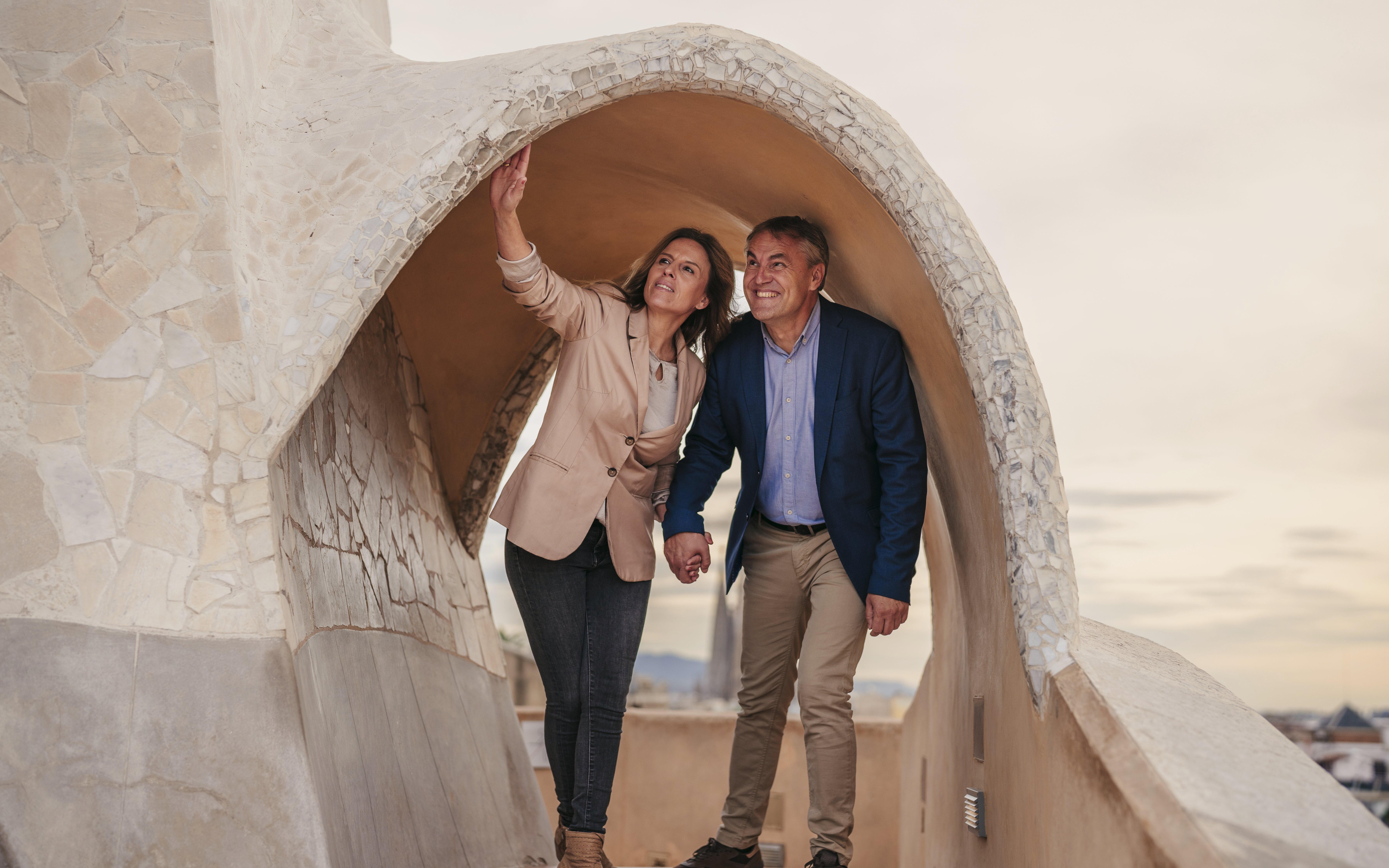 Tourists exploring rooftop architecture at Casa Mila, Barcelona.