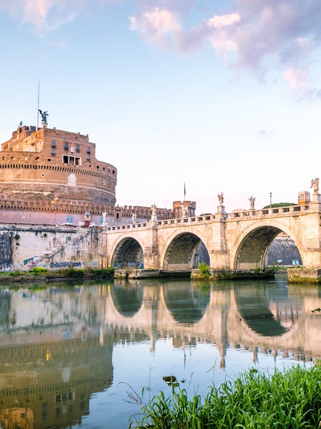 Castel Sant'Angelo and Ponte Sant'Angelo at sunset in Rome.