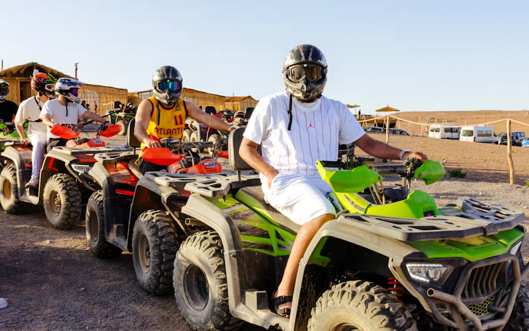 People riding quad bikes in Agafay Desert, Marrakesh.