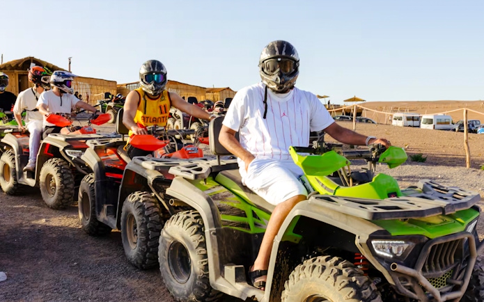 People riding quad bikes in Agafay Desert, Marrakesh.