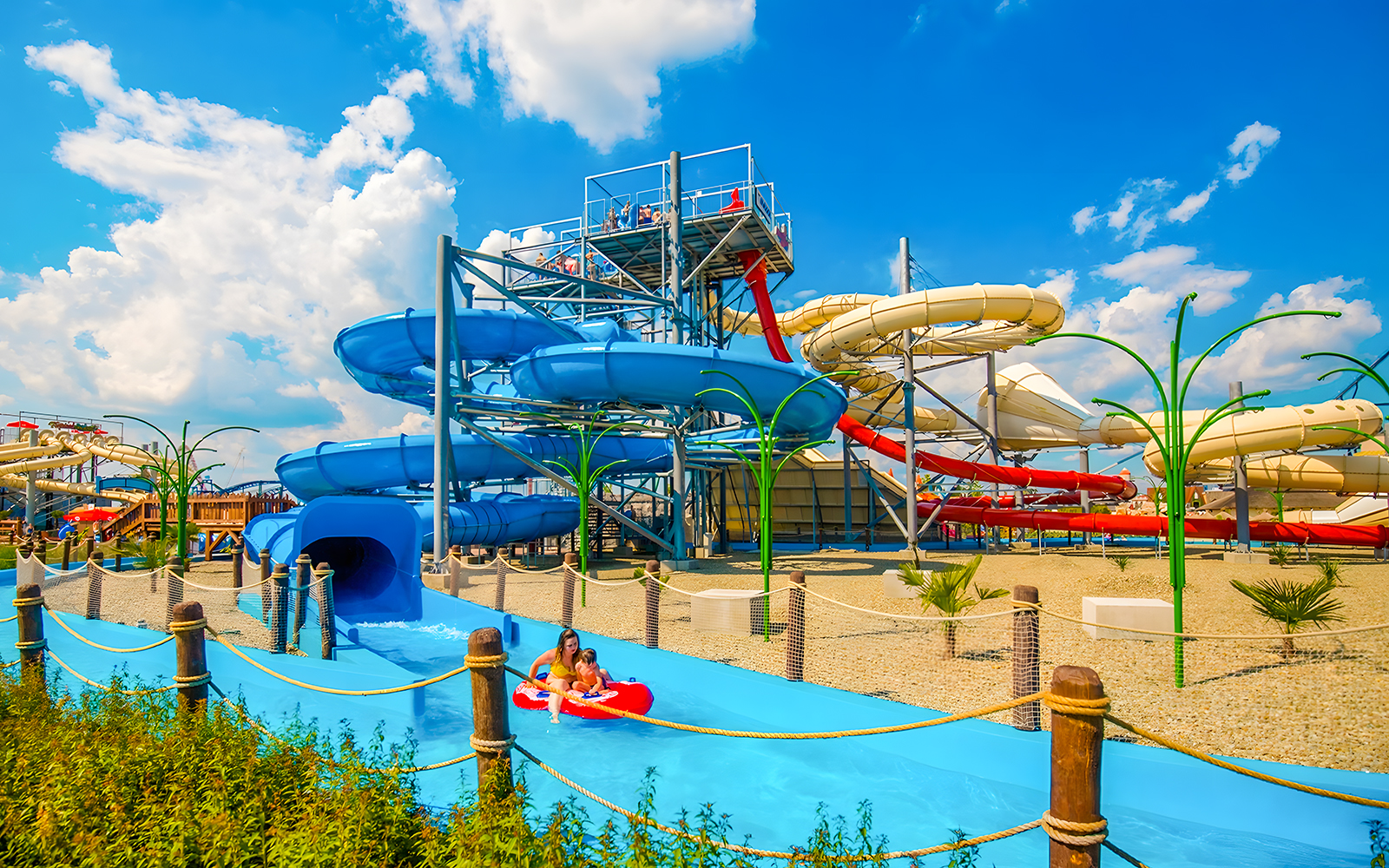 Adventure River ride at Energylandia Water Park Zone, featuring winding water slides and lush surroundings.