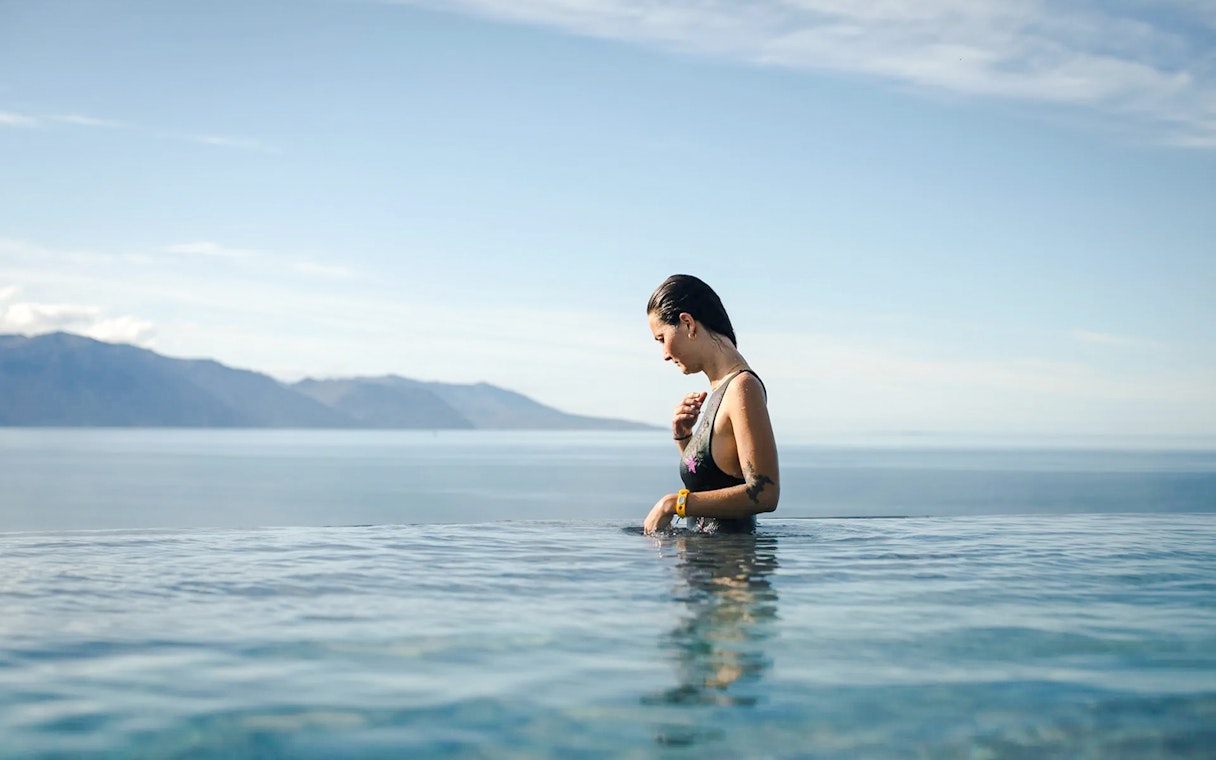 Guest enjoying Geosea Geothermal baths with ocean view in Iceland.