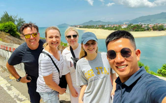 Tourists taking a selfie at a scenic stop on the Hue to Da Nang journey.