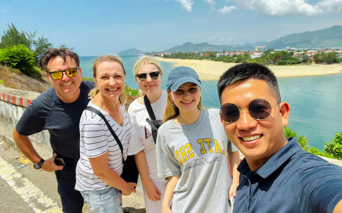 Tourists taking a selfie at a scenic stop on the Hue to Da Nang journey.