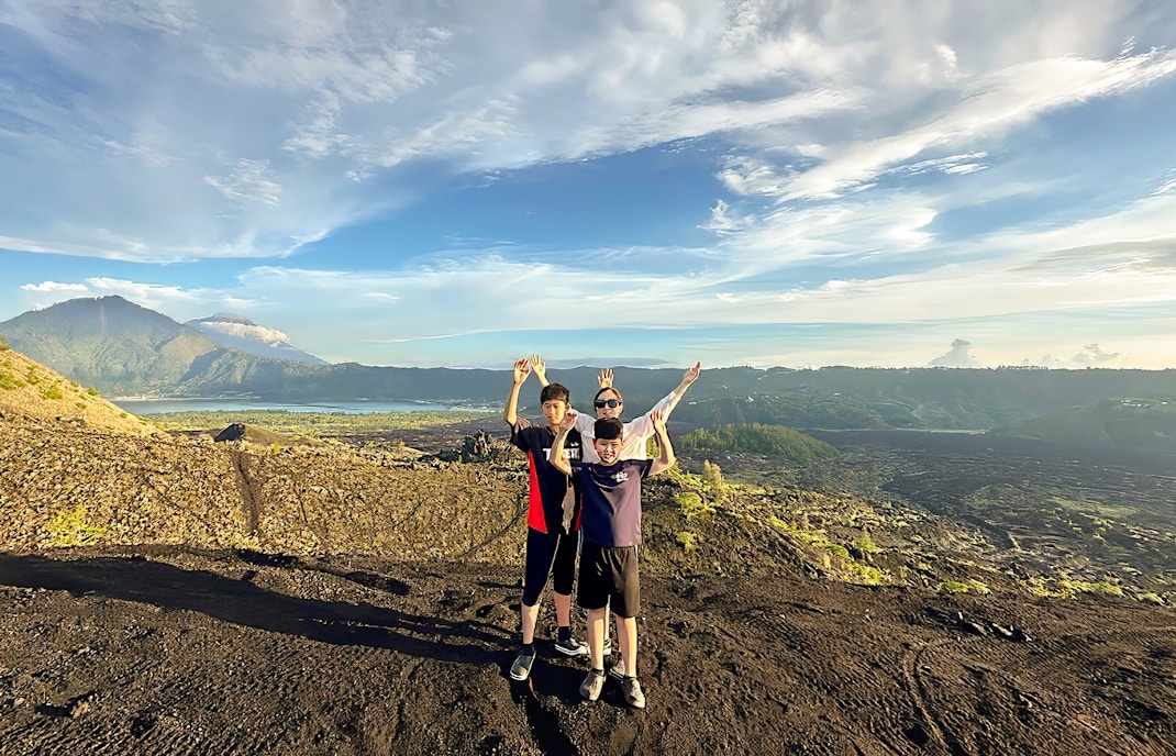 Group enjoying Kintamani sunset view with Mount Batur in the background on a 4WD Jeep tour.