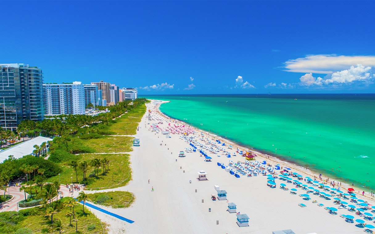 Aerial view of Miami South Beach with turquoise water and beachfront buildings.