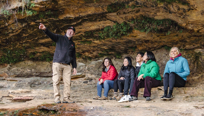 Tour guide with a tour group at a rainforest trail