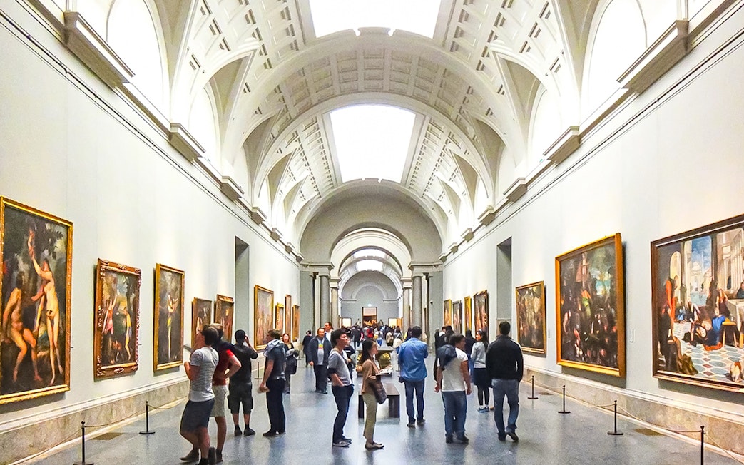 Visitors viewing paintings in a gallery at Museo del Prado, Madrid.