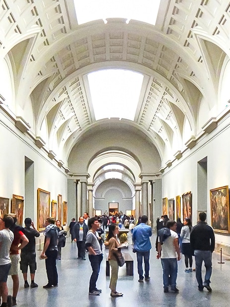 Visitors viewing paintings in a gallery at Museo del Prado, Madrid.