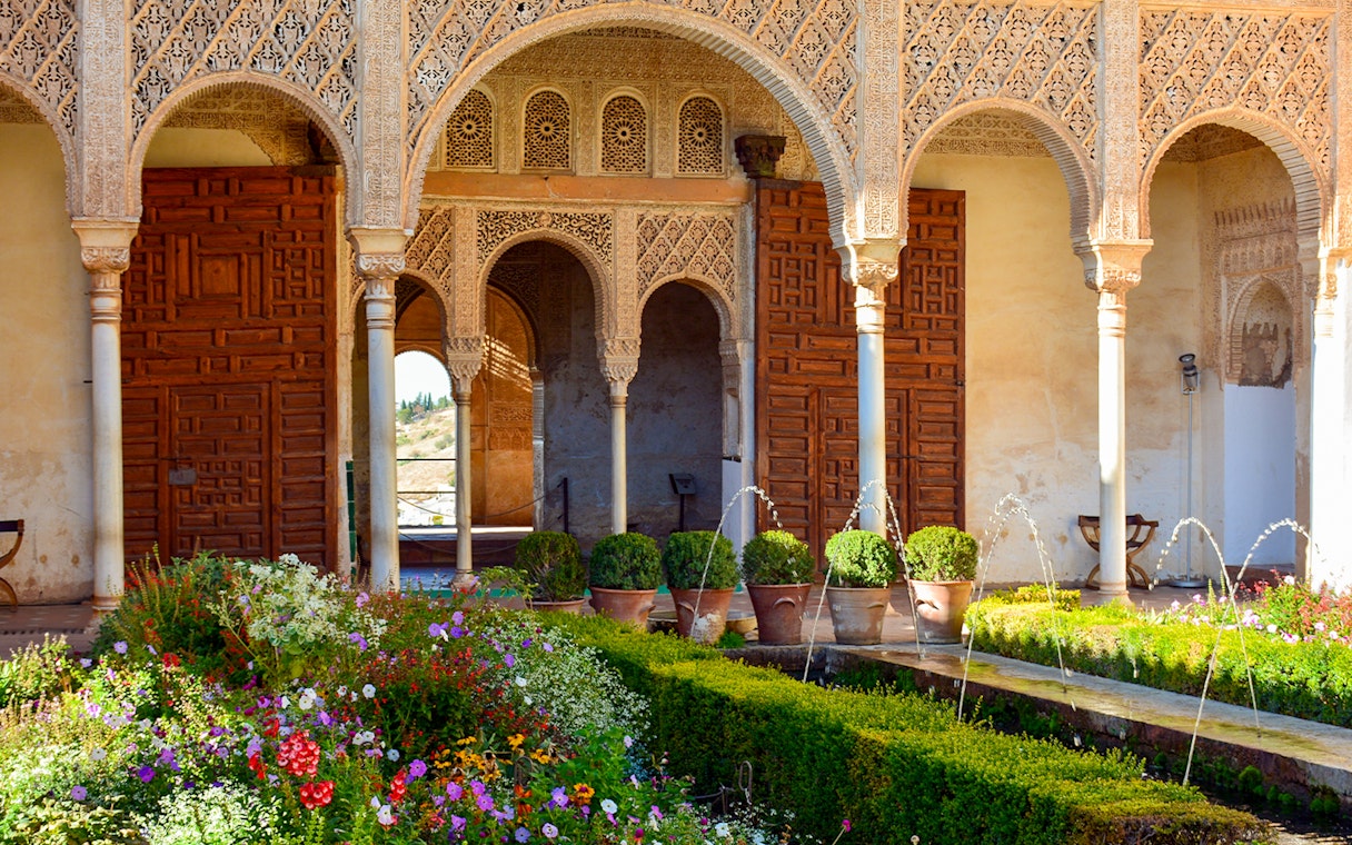 Palace of the Patio de la Acequia del Generalife, Alhambra with arches and garden.