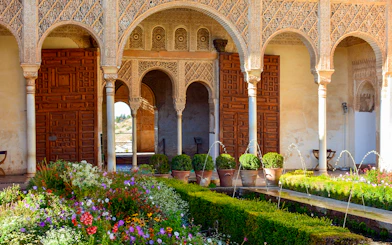 Palace of the Patio de la Acequia del Generalife, Alhambra with arches and garden.
