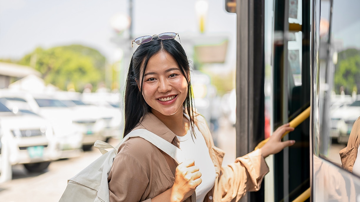Woman boarding a bus to Nami Island with a backpack.