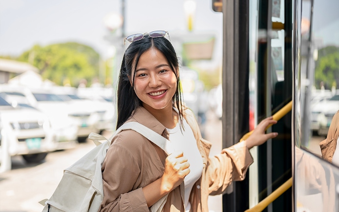Woman boarding a bus to Nami Island with a backpack.
