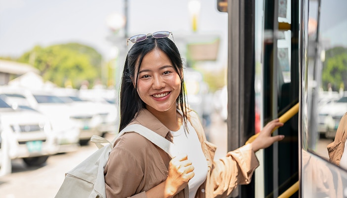 Woman boarding AC bus to Nami Island in Seoul, South Korea.