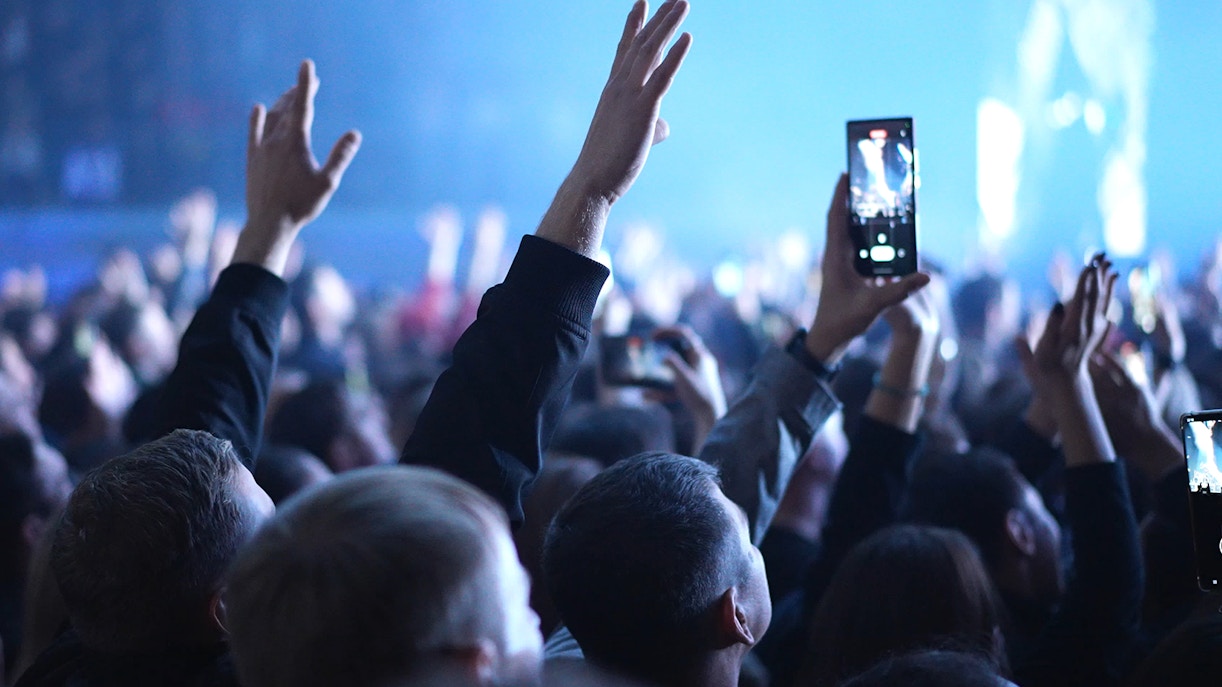 Musicians performing at a concert in Dubai with a vibrant cityscape backdrop.