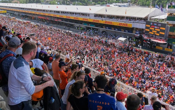 Grandstand view of Barcelona Formula 1 podium ceremony with crowd celebrating.