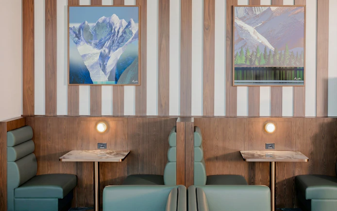Seating area with mountain artwork at Plaza Premium Lounge, Vancouver International Airport.