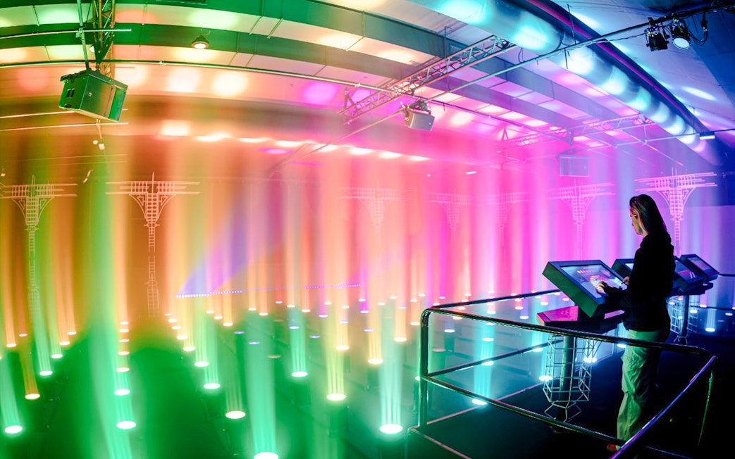 Guest interacting with light display at Amaze Amsterdam.