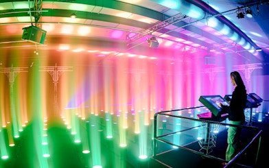 Guest interacting with light display at Amaze Amsterdam.