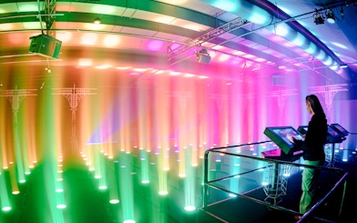 Guest interacting with light display at Amaze Amsterdam.