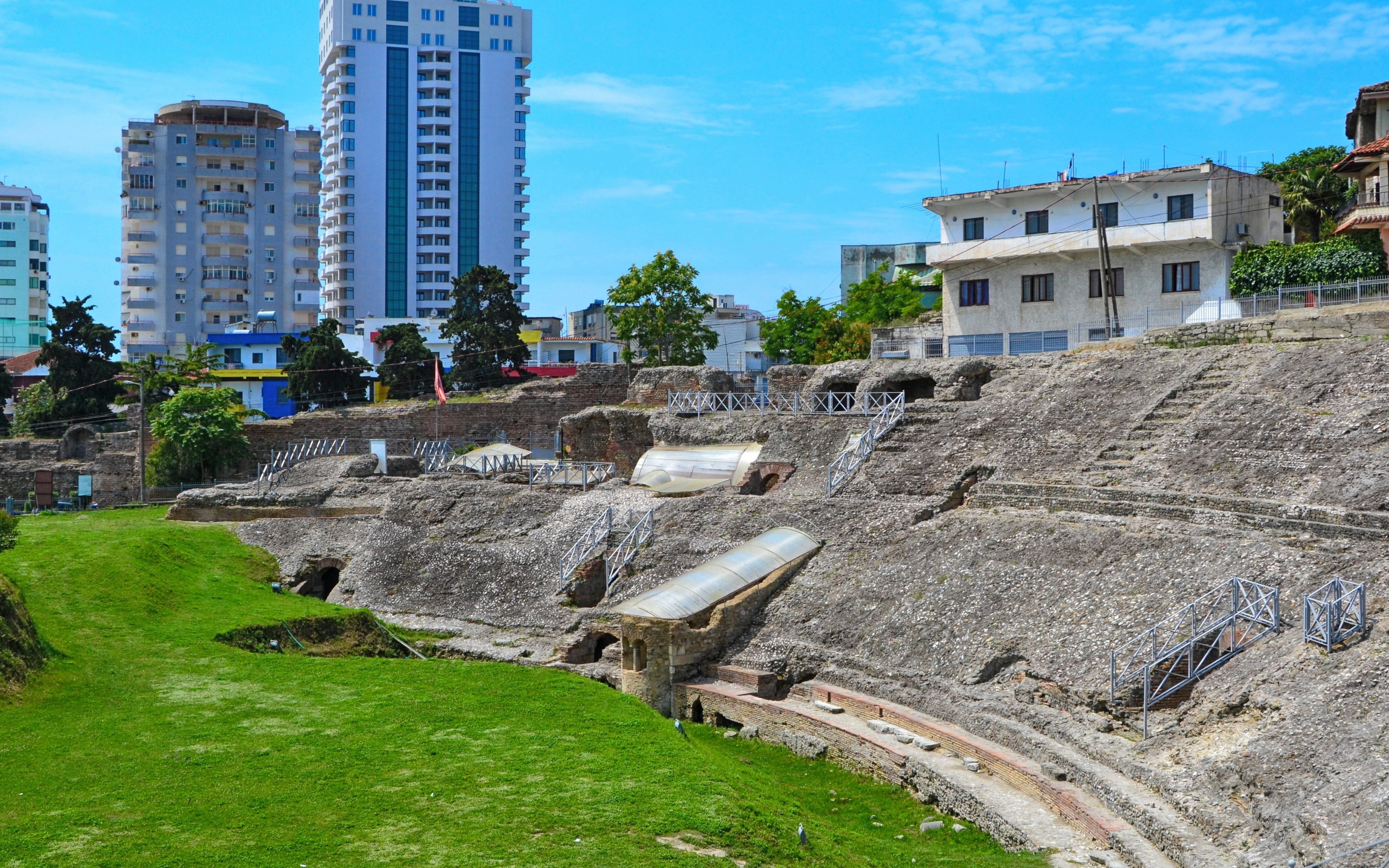 Amphitheatre of Durres with modern buildings in the background, Albania.