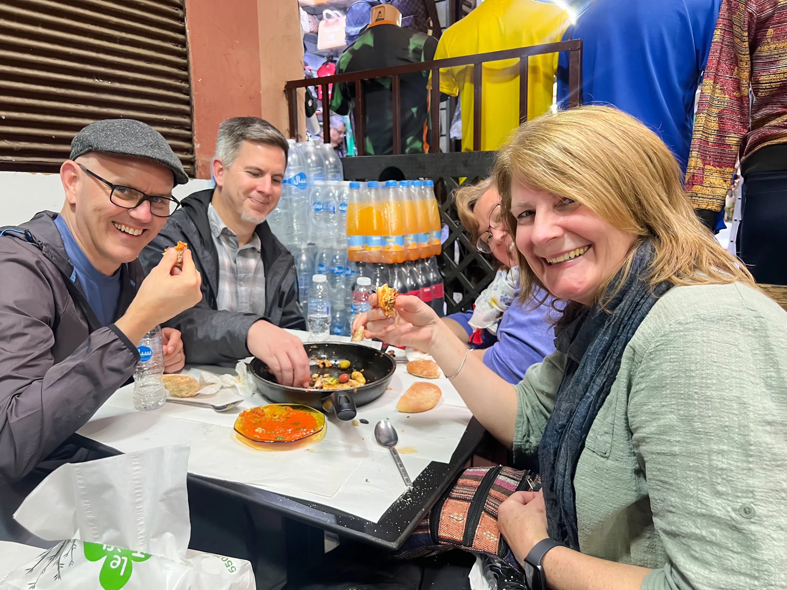 Group enjoying local cuisine on Marrakech street food tour.