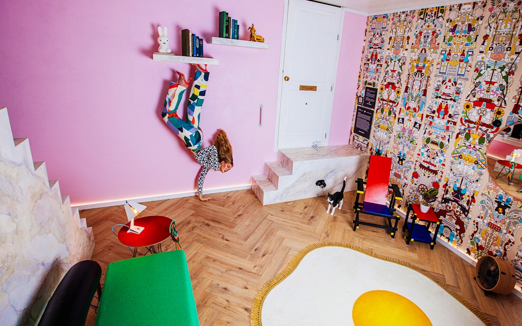 Visitors in Dutch Design Room at Upside Down Amsterdam with colorful decor and unique furniture.