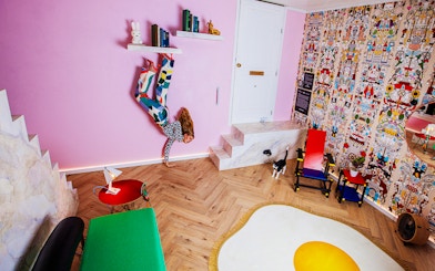 Visitors in Dutch Design Room at Upside Down Amsterdam with colorful decor and unique furniture.