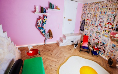 Visitors in Dutch Design Room at Upside Down Amsterdam with colorful decor and unique furniture.