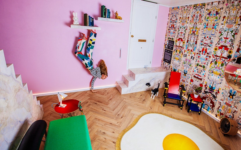 Visitors in Dutch Design Room at Upside Down Amsterdam with colorful decor and unique furniture.